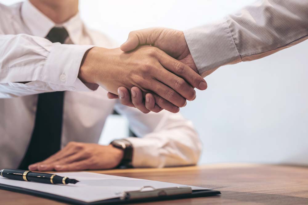 Lawyer And A Customer Shaking Hands After Signing A Contract